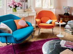 a living room filled with furniture and flowers