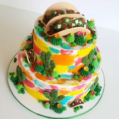 a multi layer cake decorated with cactus and succulents