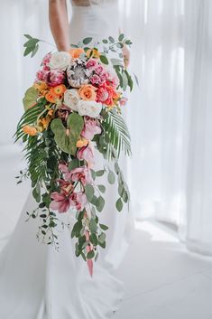 a woman holding a bouquet of flowers in her hands