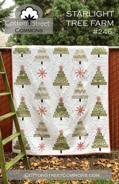 a ladder is next to a christmas tree quilt