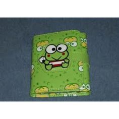 a green wallet with an angry face on it