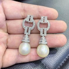 We are presenting you a HUGE pair of Art Deco, CHANDELIER, Genuine, LUSTROUS PURE WHITE, South Sea Pearls, extremely FINE AA+, LUSTROUS and Rare! Accenting the 2 pearls are 98 pieces of E/VS Natural diamonds, weighting a total of 1.58 carats. Set in GORGEOUSLY designed 18K solid white gold Art Deco earrings! PERFECT FOR SPECIAL OCCASIONS! SO BIG AND GORGEOUS! EVERYONE WILL FALL IN LOVE WITH THEM THE MINUTE THEY SEE YOU WEARING THEM! ONLY ONE ITEM AVAILABLE!! NO DUPLICATES!! WHAT YOU SEE IN THE P Luxury Diamond Pearl Earrings For Wedding, Luxury White Chandelier Earrings, Exquisite High Luster Pearl Earrings For Wedding, Luxury Round Pearl Earrings For Wedding, White Diamond Pearl Earrings For Wedding, White Elegant Chandelier Earrings For Formal Occasions, Exquisite White Pearl Earrings For Weddings, Luxury Pear-shaped Wedding Earrings, Luxury Bridal Earrings For Wedding