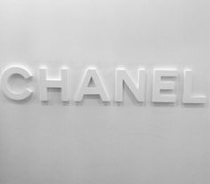 the word chanel written in white letters on a wall