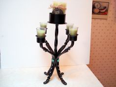 a candle holder with four candles on it