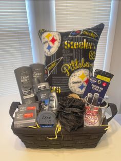 a basket filled with sports items sitting on top of a table next to a pillow