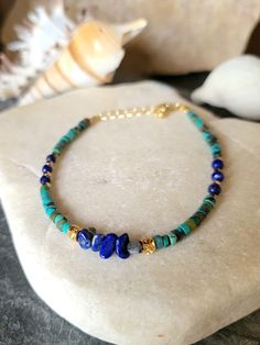 This delicate bracelet is made of small heishi roundels in real turquoise and lapis lazuli. I decorated them with fine gold-plated round beads and golden hematites. The round beads, the clasp, the rings and the chain are gilded with fine 24K, 3 micron gold made by a professional gilder. The bracelet measures from 16.5 cm to 19 cm thanks to the extension chain. Stone size approximately 3.3 mm. Boho chic bracelet, women's gift. To wear alone or combined with other bracelets. You can find a bangle Adjustable Lapis Lazuli Beaded Bracelets Bohemian Style, Bohemian Lapis Lazuli Beaded Bracelets, Blue Bohemian Heishi Beads Jewelry, Bohemian Beaded Bracelets With Lapis Lazuli Stones, Bohemian Beaded Bracelets With Lapis Lazuli, Bohemian Lapis Lazuli Beaded Bracelets With Natural Stones, Bohemian Lapis Lazuli Beaded Bracelets As Gift, Bohemian Lapis Lazuli Bracelet For Gift, Bohemian Lapis Lazuli Bracelet As A Gift