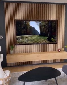 a living room with a large flat screen tv mounted on the side of a wall