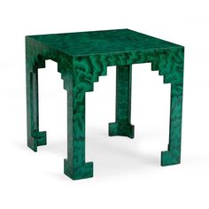 a small green table with an intricate design on it