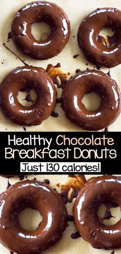 four chocolate donuts sitting on top of a piece of parchment paper with the words healthy chocolate breakfast doughnuts