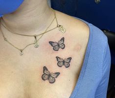 a woman with three butterflies on her chest