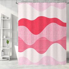 a pink and white shower curtain in a bathroom