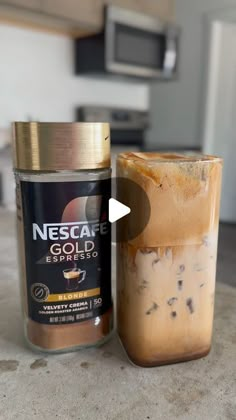 a jar of ice cream next to a canister of iced coffee on a counter