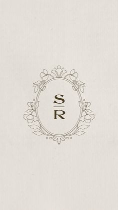 the letter s r is inscribed in a circle with flowers and leaves on it's side