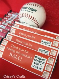 some baseballs are sitting next to each other on a red table with the words softball thank you for making this season a ball