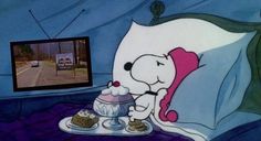 there is a cartoon dog eating cake on the bed with a tv in the background