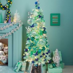 a decorated christmas tree in front of a fireplace