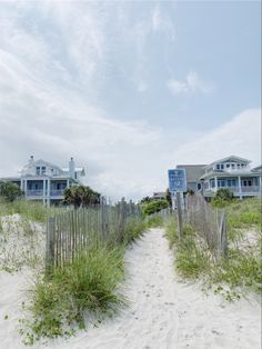 the beach is lined with houses and grass