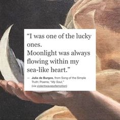 a person holding a piece of paper with the quote i was one of the lucky ones, moonlight was always flowing within my sea - like heart