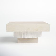 a white table sitting on top of a white floor