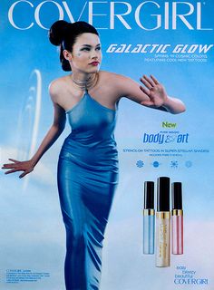 an advertisement for covergirl cosmetics featuring a woman in blue dress with her hands out