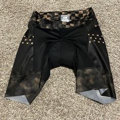 a pair of black shorts with gold stars on the side and an under - belly