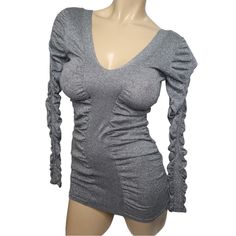 Brand: Moda International Women's Size Small Glitter Plunge V Neck Long Sleeve Knit Bodycon Mini Dress Color: Silver Approximate Measurements: Length 28" Bust 13" Sleeve 24" Materials: 70% Cotton20% Polyester10% Metallic Fibre Imported, Made In China Condition New Without Tags Sku: Scw 9 Glamorous V-neck Winter Top, V-neck Glitter Mini Dress For Party Season, Long Sleeve Fitted Shimmer Mini Dress, Fitted Long Sleeve Shimmer Mini Dress, Fitted Long Sleeve Mini Dress With Shimmer, Evening V-neck Glitter Mini Dress, Evening Fitted Lurex Mini Dress, V-neck Shimmer Mini Dress For Spring, Fitted Lurex Mini Dress For Party