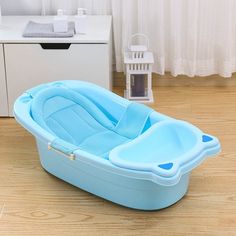 a baby bath tub sitting on top of a wooden floor