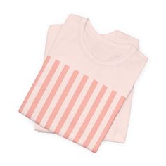 Introducing our Coral Pink Stripes Shirt, a feminine and chic addition to your wardrobe. Made with pretty pink and white vertical stripes, this classic t-shirt brings a cute and stylish touch to any casual outfit. This classic unisex jersey short sleeve tee fits like a well-loved favorite. These soft cotton t-shirts have-ribbed knit collars to bolster shaping. The shoulders are tapered for a better fit over time. Dual side seams hold the garment's shape for longer. .: Made with 100% Airlume comb Spring Cotton T-shirt With Striped Sleeves, Trendy White Top With Vertical Stripes, Trendy White T-shirt With Contrast Stripes, Cotton Tops With Vertical Stripes And Short Sleeves, Trendy Horizontal Stripe T-shirt For Spring, Pink Cotton Top With Contrast Stripes, White T-shirt With Contrast Stripes, Trendy T-shirt With Horizontal Stripe For Spring, Casual White Vertical Stripes T-shirt