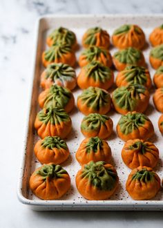 there are many small pumpkins on the tray