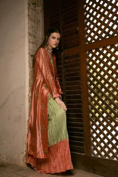 DETAILS Front open jacket, diagonal pleated bodice and attached skirt with hand-embroidered motifs. Inner contrasting shirt with an organza scalloped hem, hand-embroidered. Paired with a two-toned, crushed, two part lehnga. COLOR Coral / Green SIZE Custom Order - A measurement guide will be sent upon order. Model is 5'7 MATERIAL Jacket - Sheesha SilkShirt - Raw Silk / Silk OrganzaLehnga - Khaddi Silk PRODUCT CODE 300000-08-26 PRODUCT OF PAKISTAN GARMENT CARE Handle With Care Professionally Dry C Fitted Long Sleeve Tissue Silk Dress, Fitted Tissue Silk Set With Long Sleeves, Fitted Long Sleeve Tissue Silk Set, Sheer Dupatta Long Sleeve Raw Silk Dress, Raw Silk Long Sleeve Dress With Sheer Dupatta, Formal Long Sleeve Chanderi Dress, Formal Sets With Dupatta For Spring, Formal Spring Sets With Dupatta, Spring Formal Set With Dupatta