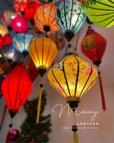 many colorful lanterns are hanging from the ceiling