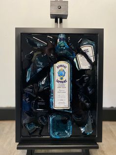 a bottle of alcohol sitting inside of a black box