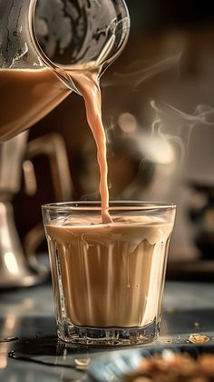 coffee being poured into a glass cup