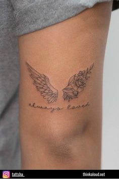 a woman with a tattoo on her thigh that says, always be loved and has two wings