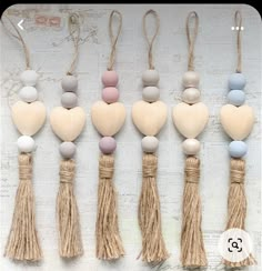 six wooden hearts and tassels hanging from strings