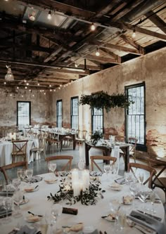 an empty dining room is set with white linens and place settings for the guests