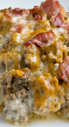 a white plate topped with meat and cheese covered casserole