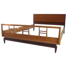 a wooden bed frame with drawers on each side