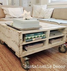 a coffee table made out of an old crate with books and magazines on the top