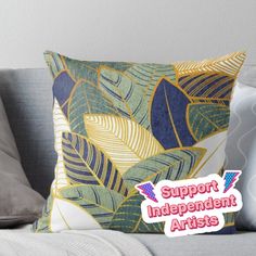 a pillow with the words support independent artists on it sitting on top of a couch