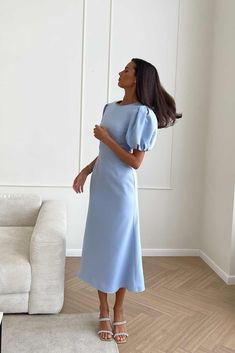 A simple chic midi godet dress in blue, an easy go-for option for every occasion. The dress has a fitted cut with a classic round neck and puffy sleeves that flatters rounded, full arms. The dress favorably emphasizes the silhouette, tightly fitting the hips and expanding to the bottom. Long Sleeve Midi Formal Dress, Blue Chic Outfit Classy, Midi Dresses Aesthetic, Modest Chic Dresses, Simple Blue Dress Classy, Classic Wedding Dress Modest, Light Blue Wrap Dress, Elegant Modest Dress, Modest Simple Dresses