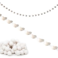 some white balls are on a string and one is in front of the ball garland