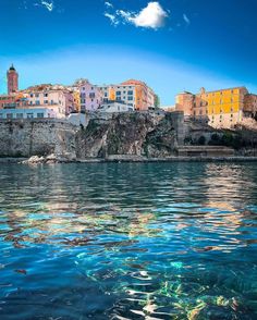 the water is clear and blue with buildings on it