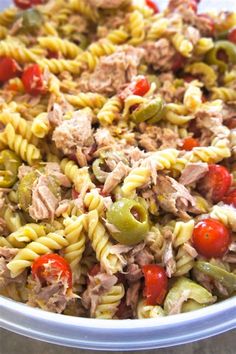 a bowl filled with pasta, meat and vegetables