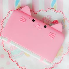 a pink kitty phone case sitting on top of a table