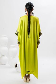 Green long kaftan kurta with hand embroidered ajrakh patch yoke in front. Comes with pant.
Components: 2
Pattern: Embroidered
Type Of Work: Ajrakh, Sequin, Zari, Thread
Neckline: Notched
Sleeve Type: Batwing
Fabric: Satin
Color: Green
Other Details: 
Note: Potli bag held by the model is not for sale
Occasion: Mehendi and Haldi - Aza Fashions Festive Traditional Pattern Maxi Kaftan, Festive Traditional Maxi Kaftan, Festive Traditional Pattern Maxi Length Kaftan, Festive Maxi Length Kaftan With Traditional Patterns, Festive Maxi-length Kaftan With Traditional Patterns, Traditional Pattern Maxi Kaftan For Festivals, Traditional Pattern Maxi Length Kaftan For Festivals, Traditional Drape Kaftan With Patterns, Traditional Patterned Festival Maxi Kaftan