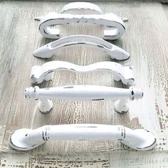 four white handles on a wooden surface