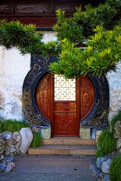 an entrance to a building with plants growing out of it