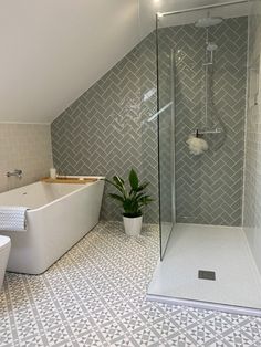 a bathroom with a tub, toilet and shower in it's corner area next to a sink