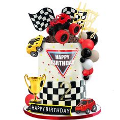 a birthday cake decorated with cars and balloons